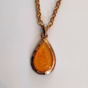 KC teardrop shaped pendant necklace.